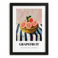Grapefruit – on Striped Tablecloth, Fruit Still Life, in sleek black frame